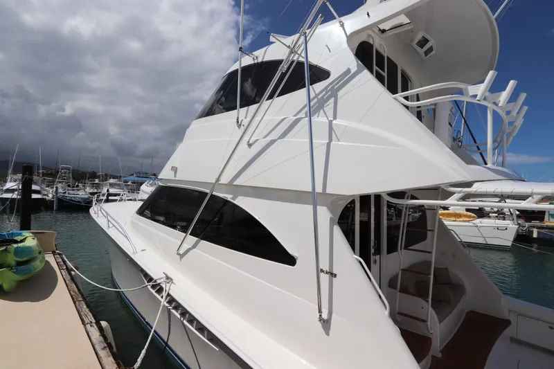 Slide: The Image of 2013 Viking 66 yacht docked at marina under cloudy sky. - 52