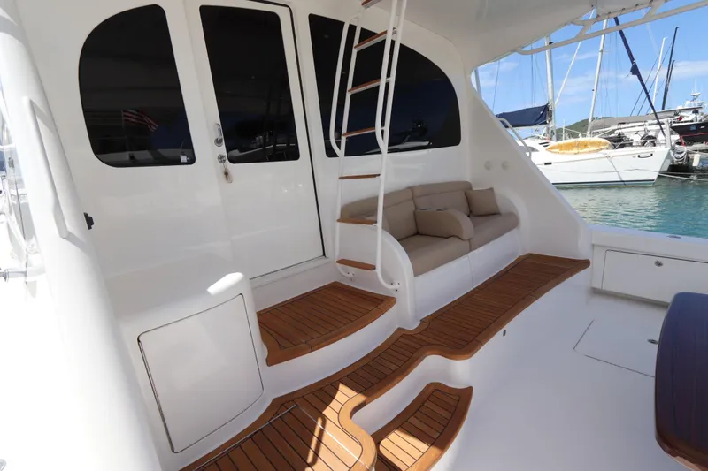 Slide: The Image of Luxurious 2013 Viking 66 yacht deck with teak flooring and comfortable seating. - 53