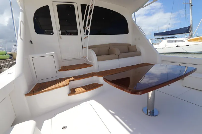 Slide: The Image of Luxurious 2013 Viking 66 yacht interior with wooden steps and polished table. - 54