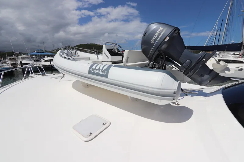 Slide: The Image of White Novurania boat with Yamaha motor on Viking 66 yacht, 2013 model, docked in marina. - 55