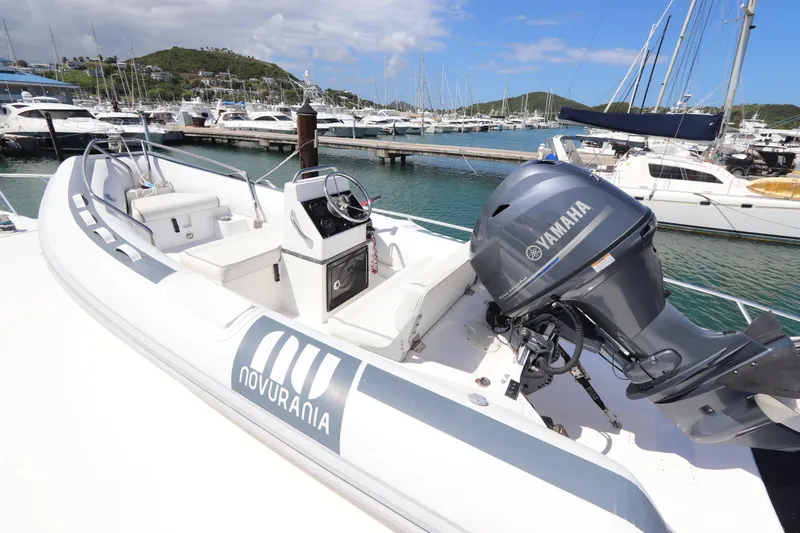Slide: The Image of Novurania boat with Yamaha engine docked at marina, surrounded by yachts. - 56