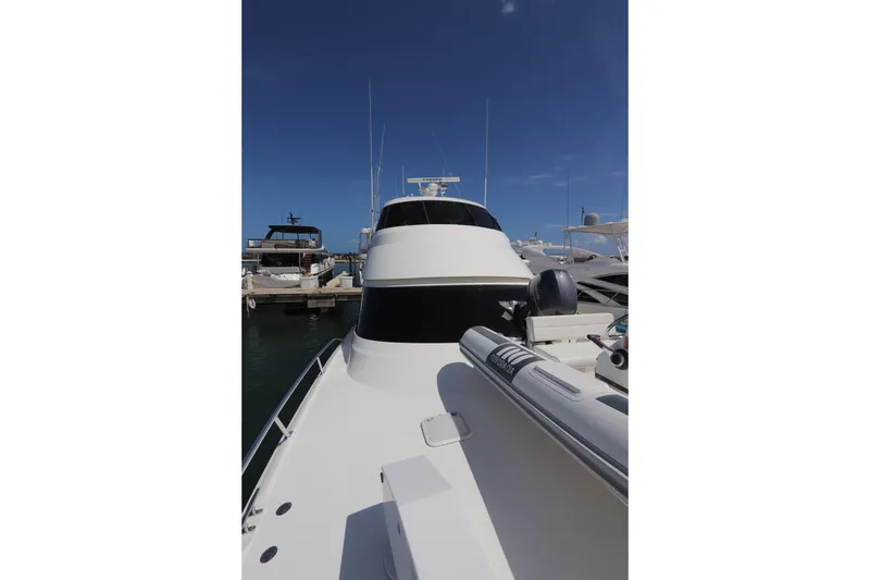 Slide: The Image of 2013 Viking 66 yacht docked at marina under clear blue sky. - 60