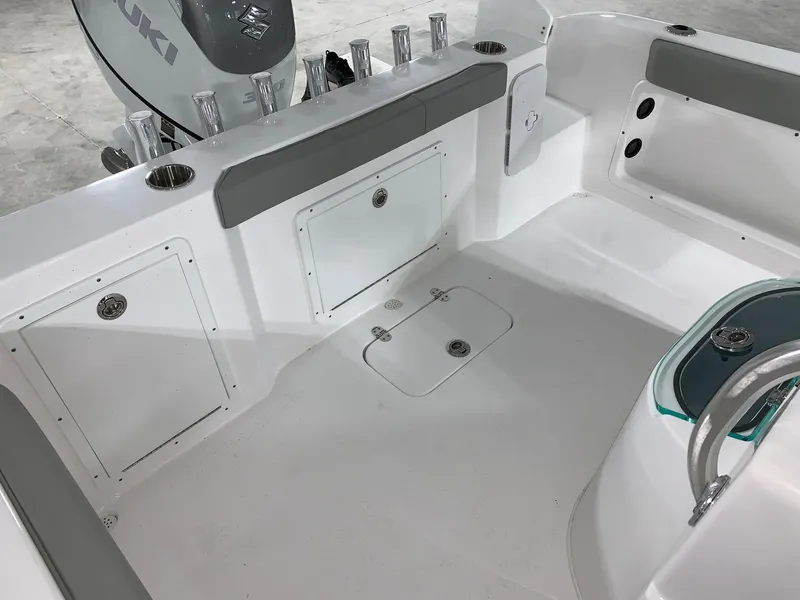 Slide: The Image of 2024 Cape Horn 22 OS boat interior with storage compartments and Suzuki outboard motor. - 5