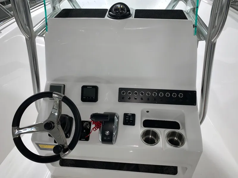 Slide: The Image of 2024 Cape Horn 22 OS boat console with steering wheel and controls. - 6