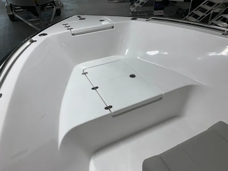 Slide: The Image of 2024 Cape Horn 22 OS boat interior, spacious white deck with storage compartments. - 13