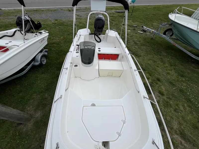 Slide: The Image of 2024 Boston Whaler 160 Super Sport boat on grass, top view. - 3