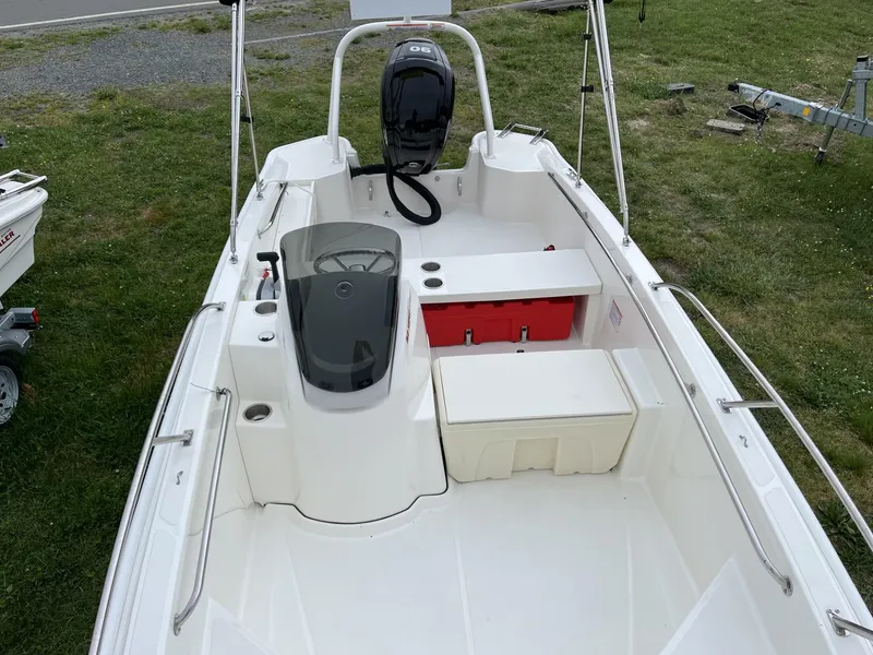 Slide: The Image of 2024 Boston Whaler 160 Super Sport boat interior with seating and storage compartments. - 7