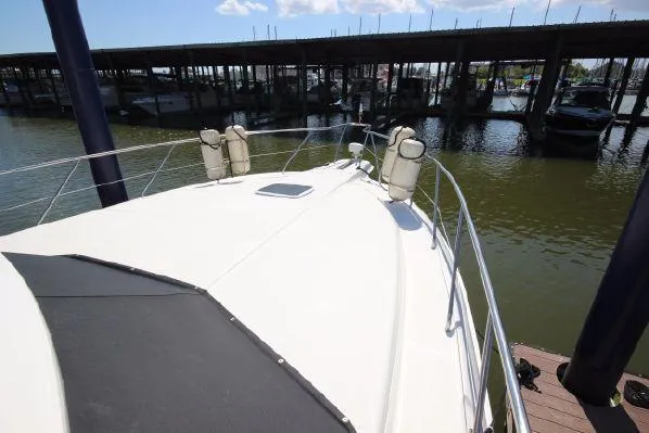 Slide: The Image of Deck of a 2001 Silverton 42 Convertible boat in harbor. - 12