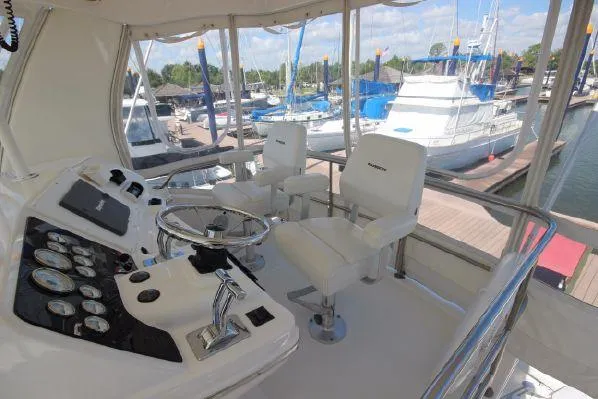 Slide: The Image of Interior view of 2001 Silverton 42 Convertible yacht at the marina. - 17