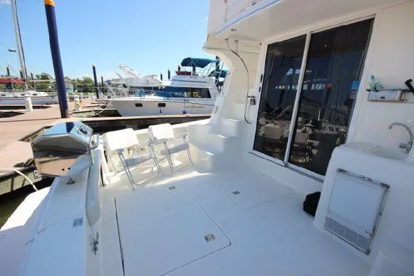 Slide: The Image of Deck of a 2001 Silverton 42 Convertible boat in harbor. - 23