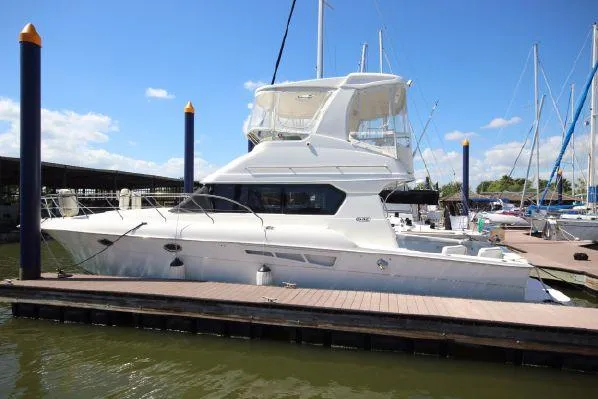 Slide: The Image of 2001 Silverton 42 Convertible Yacht docked at marina. - 3
