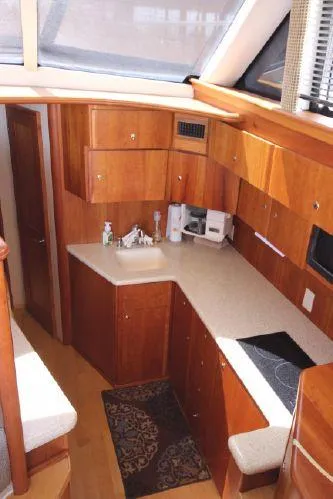 Slide: The Image of Interior of 2001 Silverton 42 Convertible yacht featuring elegant kitchen. - 33