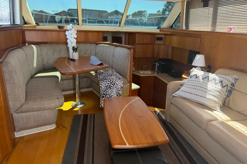 Slide: The Image of Interior of 2001 Silverton 42 Convertible yacht with cozy seating and elegant decor. - 57