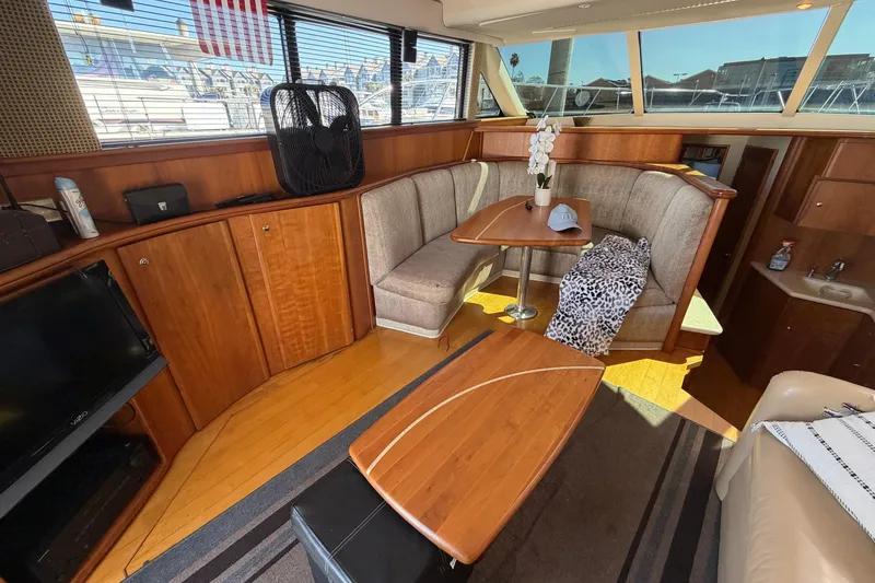 Slide: The Image of Luxurious interior of a 2001 Silverton 42 Convertible yacht with cozy seating and elegant wood finishes. - 59
