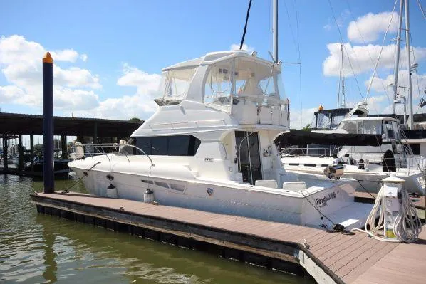 Slide: The Image of 2001 Silverton 42 Convertible Yacht docked in sunny marina. - 6
