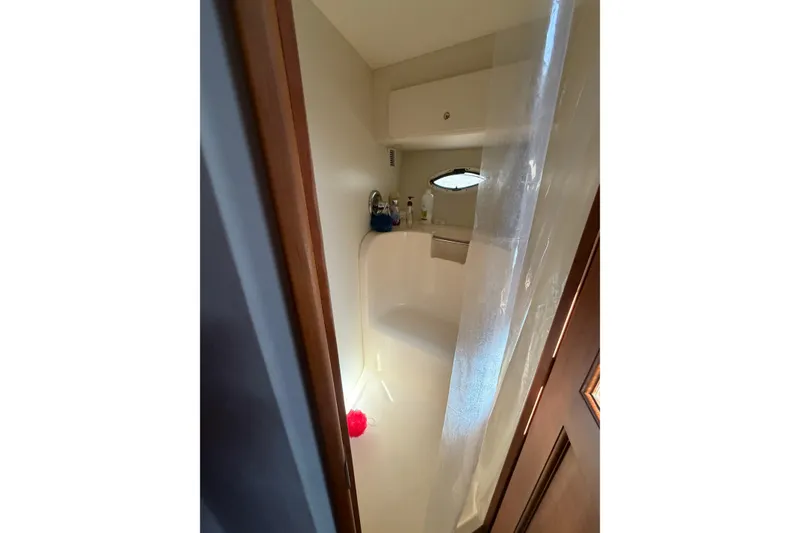 Slide: The Image of Bathroom interior of 2001 Silverton 42 Convertible yacht with shower and porthole. - 65