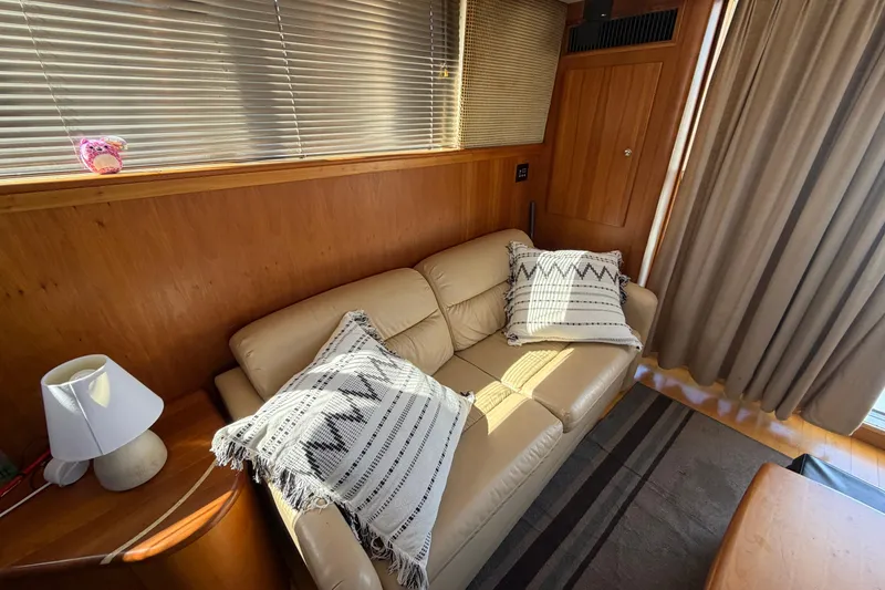 Slide: The Image of Interior of 2001 Silverton 42 Convertible yacht with beige sofa and decorative pillows. - 67