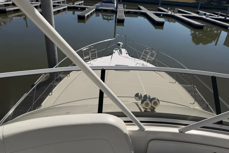 Slide: The Image of 2001 Silverton 42 Convertible yacht docked in a marina, viewed from the helm. - 68