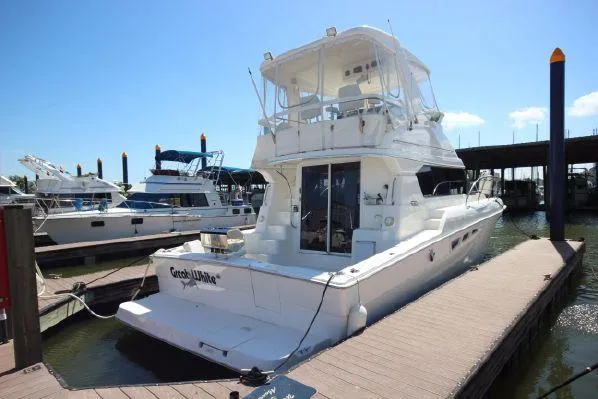 Slide: The Image of 2001 Silverton 42 Convertible yacht docked at marina. - 7