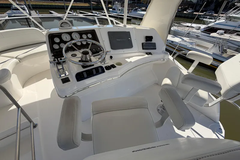 Slide: The Image of Cockpit of 2001 Silverton 42 Convertible yacht with steering wheel and control panel. - 72