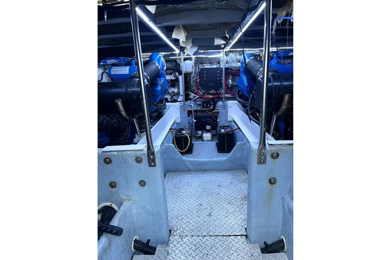 Slide: The Image of Engine room of a 2001 Silverton 42 Convertible yacht, showcasing dual engines and equipment. - 74