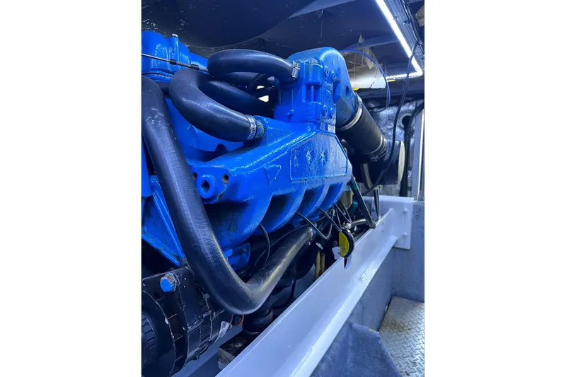 Slide: The Image of Engine compartment of a 2001 Silverton 42 Convertible boat, featuring blue engine components. - 75