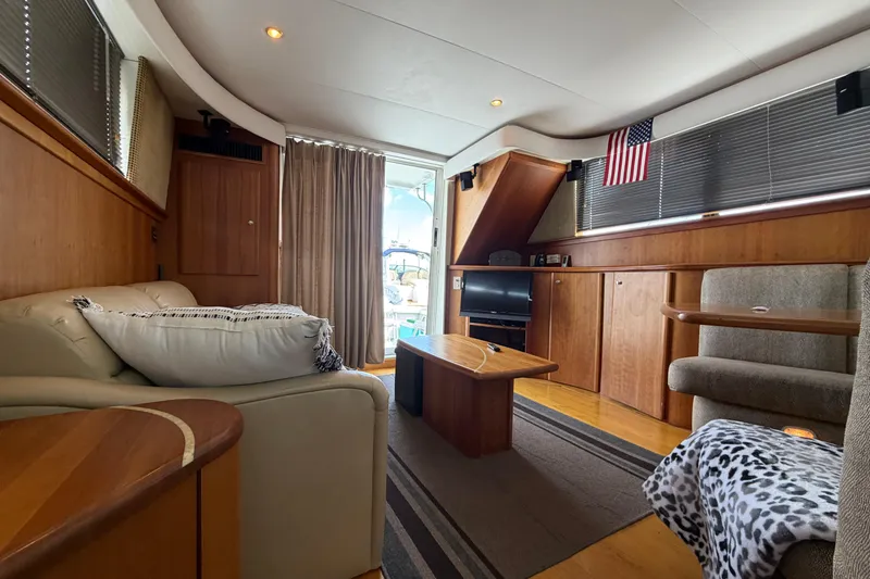 Slide: The Image of Luxurious interior of 2001 Silverton 42 Convertible yacht with cozy seating and elegant wood finishes. - 78