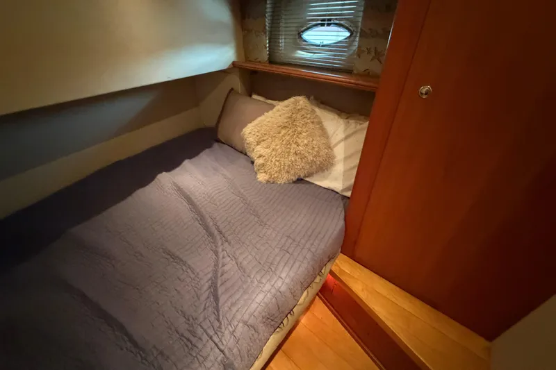 Slide: The Image of Cozy cabin interior of 2001 Silverton 42 Convertible yacht with plush bedding. - 80