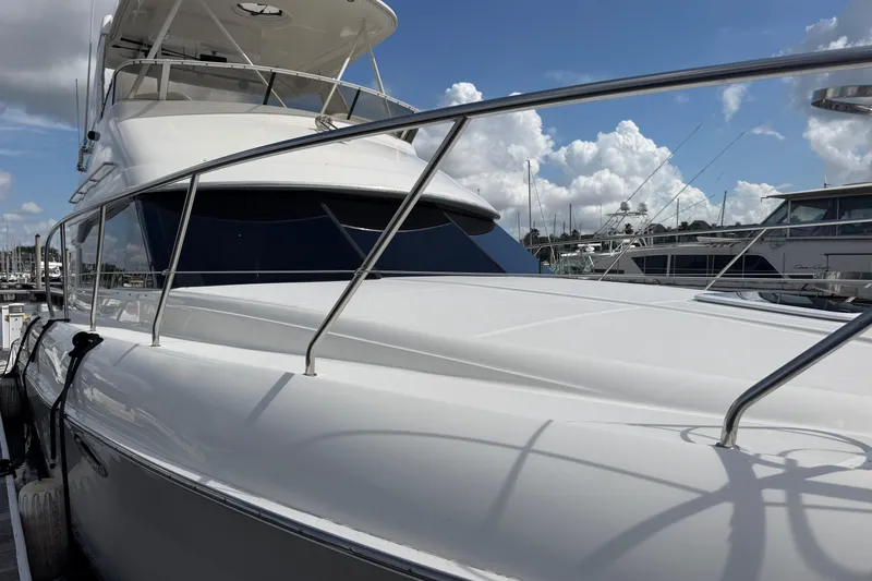 Slide: The Image of 2001 Silverton 42 Convertible yacht docked under a partly cloudy sky. - 84