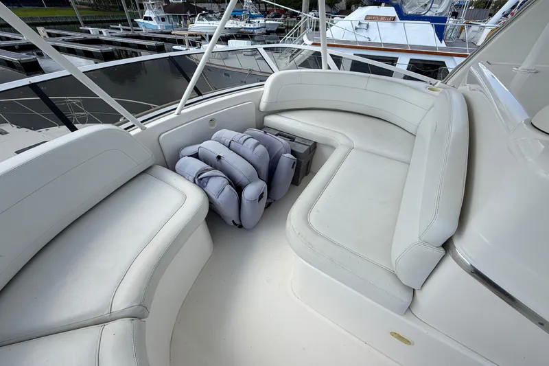 Slide: The Image of 2001 Silverton 42 Convertible yacht seating area with white cushions and life jackets. - 85