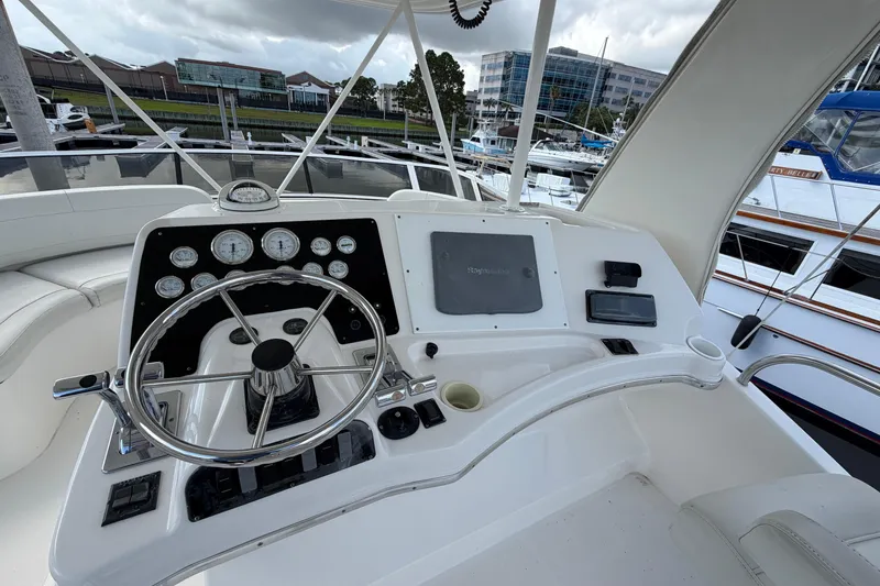 Slide: The Image of 2001 Silverton 42 Convertible yacht helm with steering wheel and navigation instruments. - 87