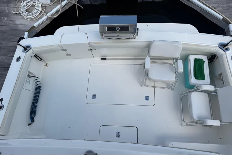 Slide: The Image of 2001 Silverton 42 Convertible boat deck with chairs and a grill. - 88