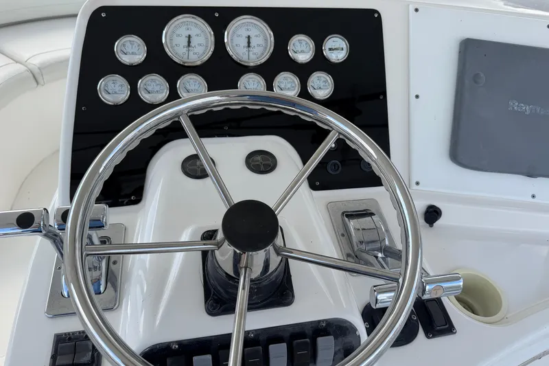Slide: The Image of Steering wheel and gauges of a 2001 Silverton 42 Convertible boat. - 89