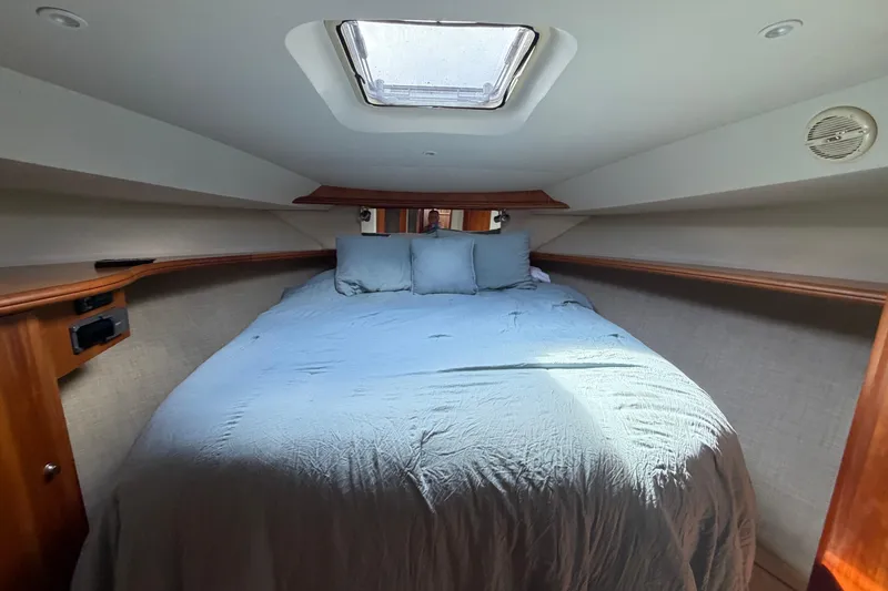 Slide: The Image of Cozy bedroom interior of 2001 Silverton 42 Convertible yacht with skylight. - 92