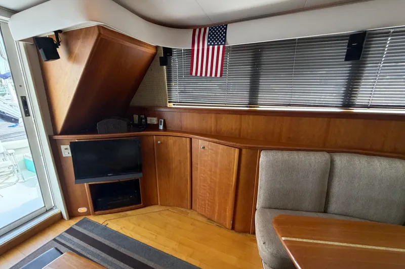 Slide: The Image of Interior of 2001 Silverton 42 Convertible yacht with TV, American flag, and seating area. - 94