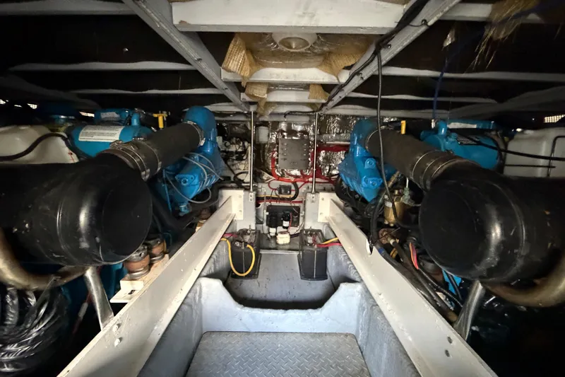 Slide: The Image of Engine room of a 2001 Silverton 42 Convertible yacht, showcasing dual engines and mechanical components. - 96