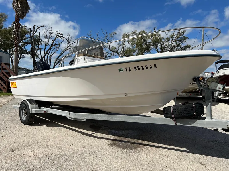 The Image of 1998 Sea Hunt 200 Triton boat on trailer under blue sky. - 0