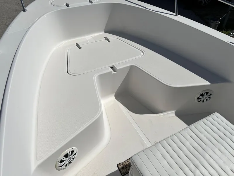 Slide: The Image of 1998 Sea Hunt 200 Triton boat interior with white seating and storage compartments. - 3