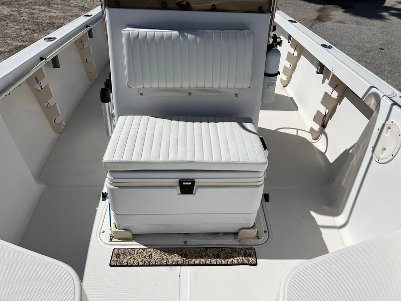 Slide: The Image of 1998 Sea Hunt 200 Triton boat interior with white seating and storage. - 4