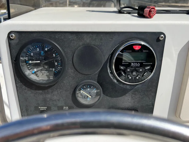 Slide: The Image of Dashboard of a 1998 Sea Hunt 200 Triton boat with gauges and stereo system. - 5