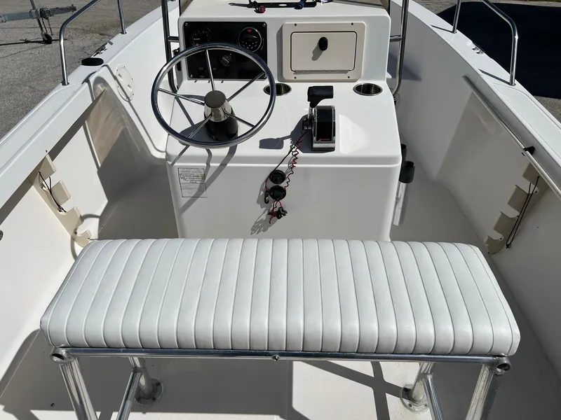 Slide: The Image of Interior of a 1998 Sea Hunt 200 Triton boat with steering wheel and seating. - 6