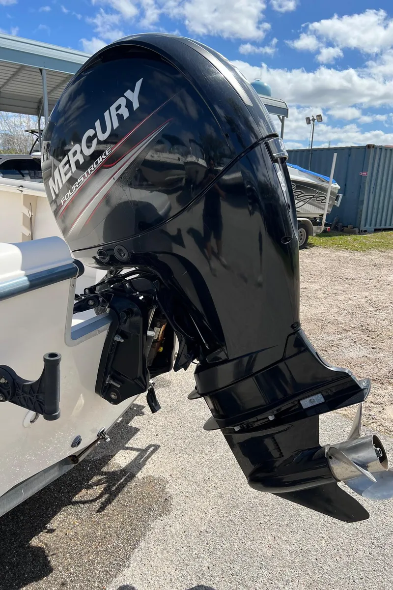 Slide: The Image of Outboard motor on a 1998 Sea Hunt 200 Triton boat under a sunny sky. - 8