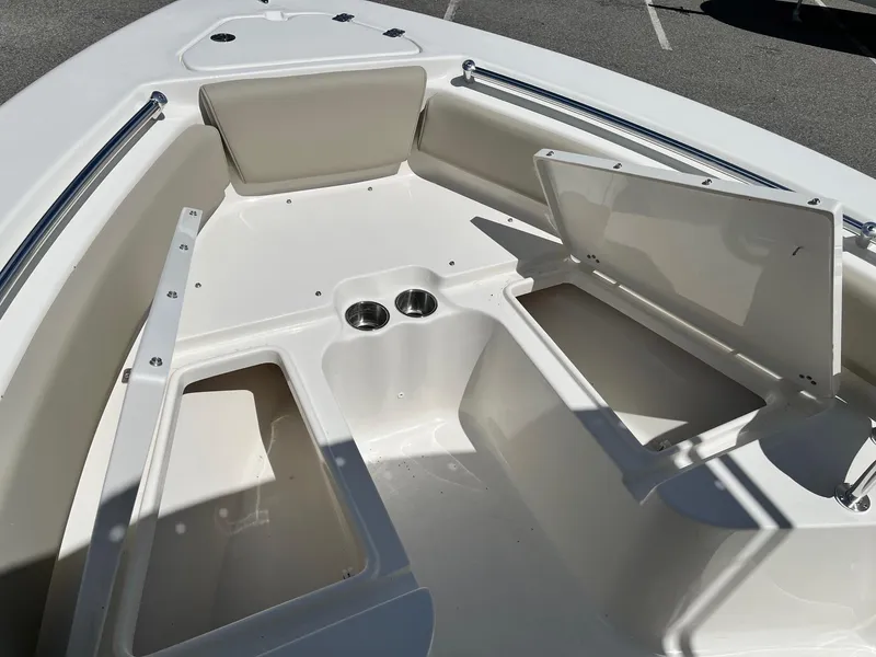 Slide: The Image of 2026 Key West 219 FS boat interior with storage compartments and cup holders. - 10