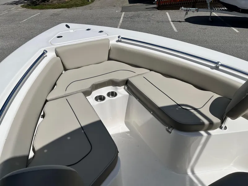 Slide: The Image of 2026 Key West 219 FS boat interior with cushioned seating and cup holders. - 12