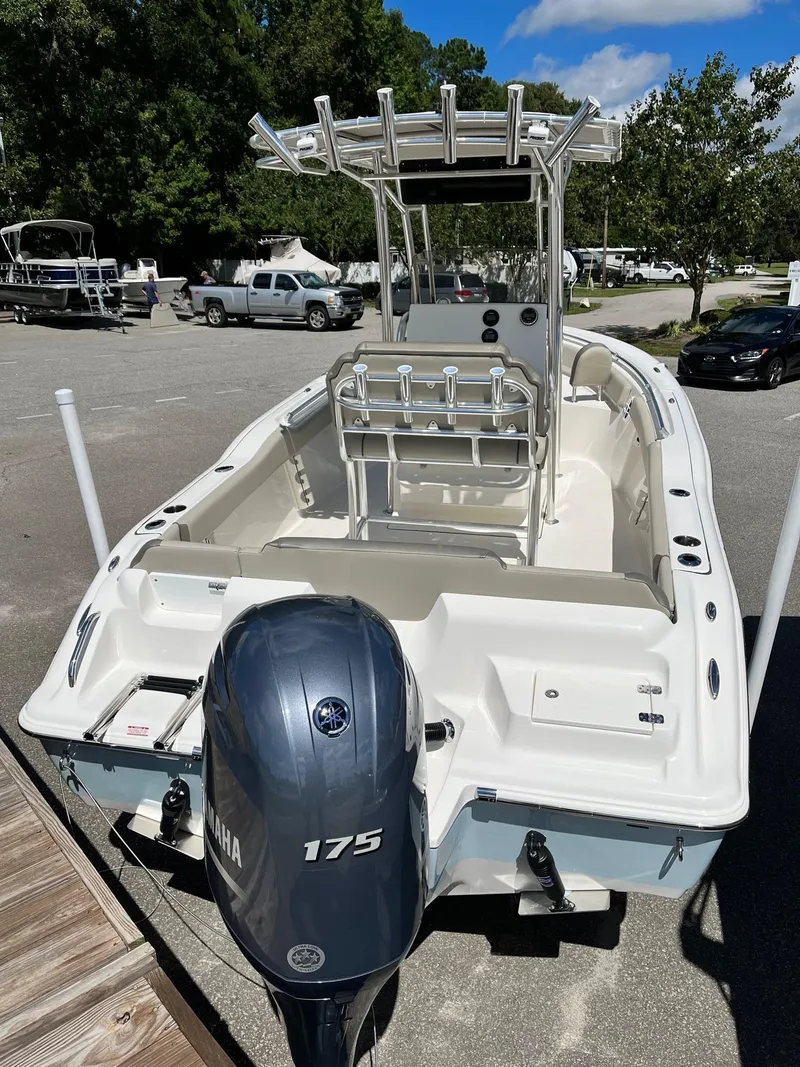 Slide: The Image of 2026 Key West 219 FS boat with Yamaha 175 engine, parked outdoors. - 2
