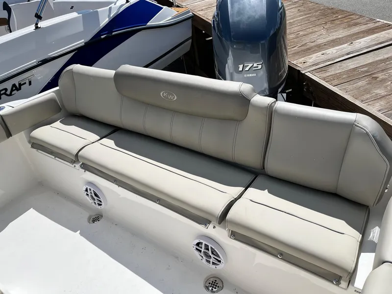 Slide: The Image of 2026 Key West 219 FS boat with beige seating and 175 horsepower engine at dock. - 6