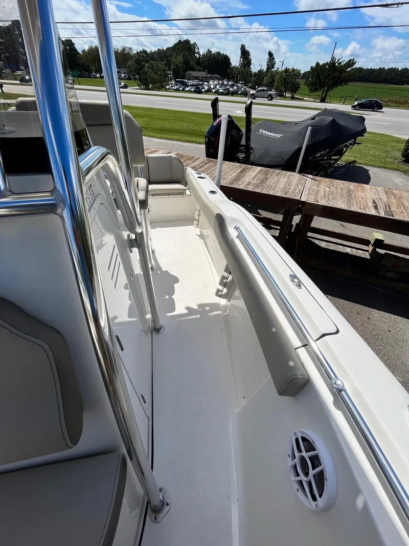 Slide: The Image of 2026 Key West 219 FS boat deck with seating and railing, parked outdoors. - 3