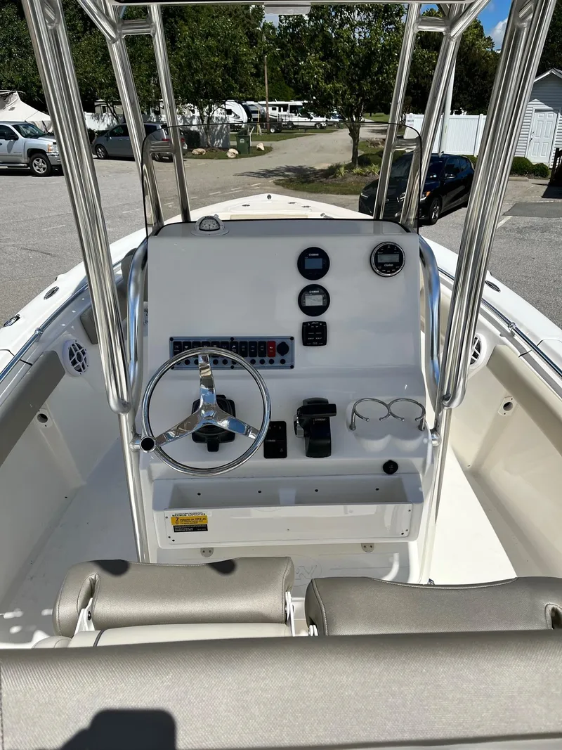 Slide: The Image of 2026 Key West 219 FS boat console with steering wheel and gauges, parked outdoors. - 6