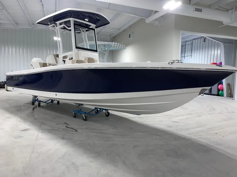 Slide: The Image of 2024 Robalo 246 Cayman boat in showroom, side view. - 1