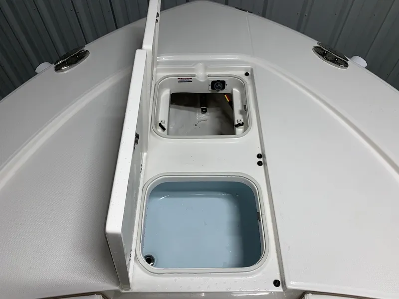 Slide: The Image of 2024 Robalo 246 Cayman boat storage compartments. - 16
